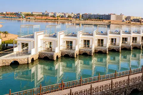 KI-Illustration: Weiße Bungalows am Wasser im Bellagio Beach Resort & Spa
