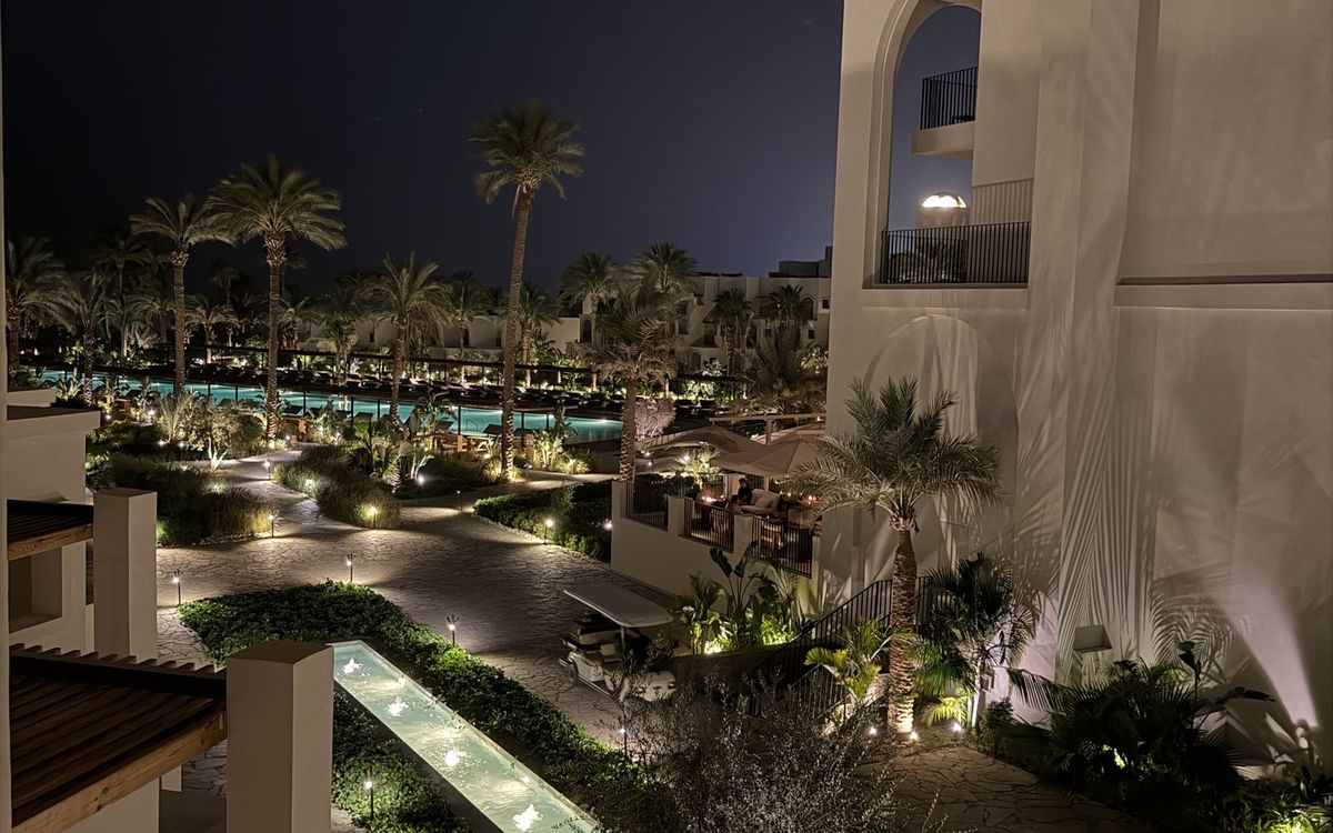 Beleuchtete Gartenwege, Palmen und Pools im Serry Beach Resort in Hurghada am Abend